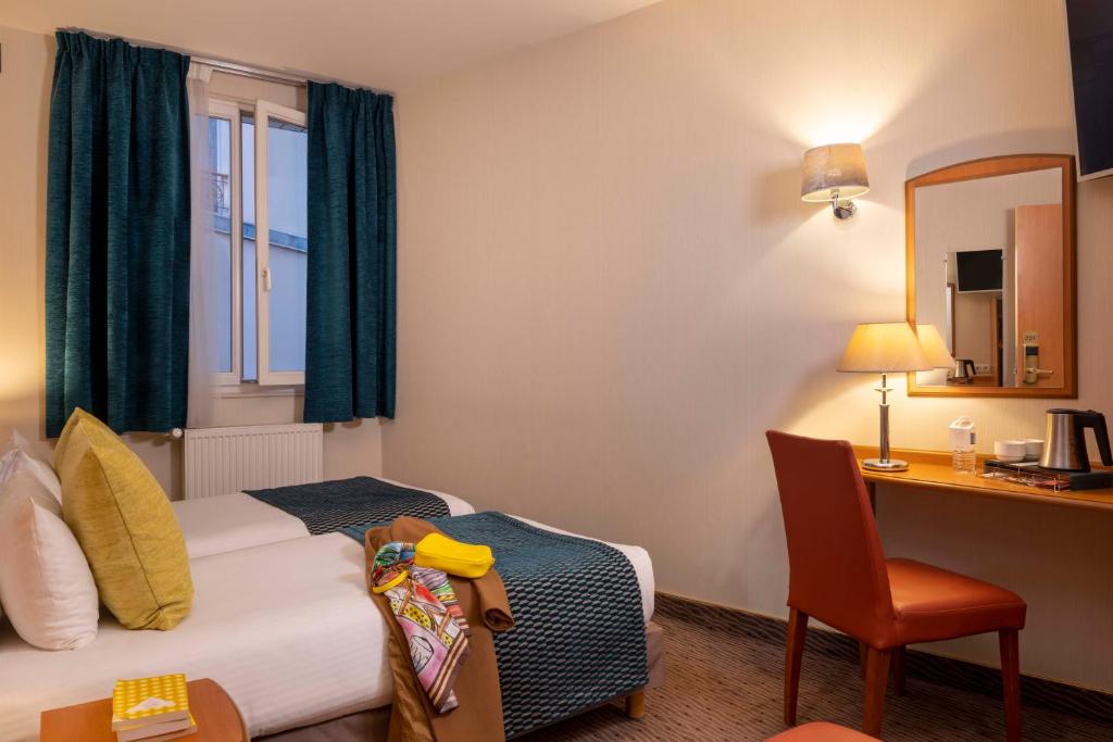 Un ou plusieurs lits dans un hébergement de l'établissement Hôtel L'Interlude