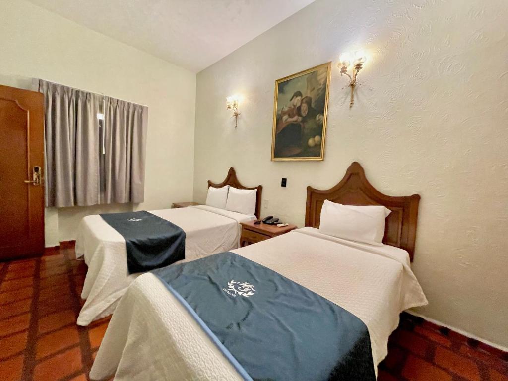 Postel nebo postele na pokoji v ubytování Hotel Frances