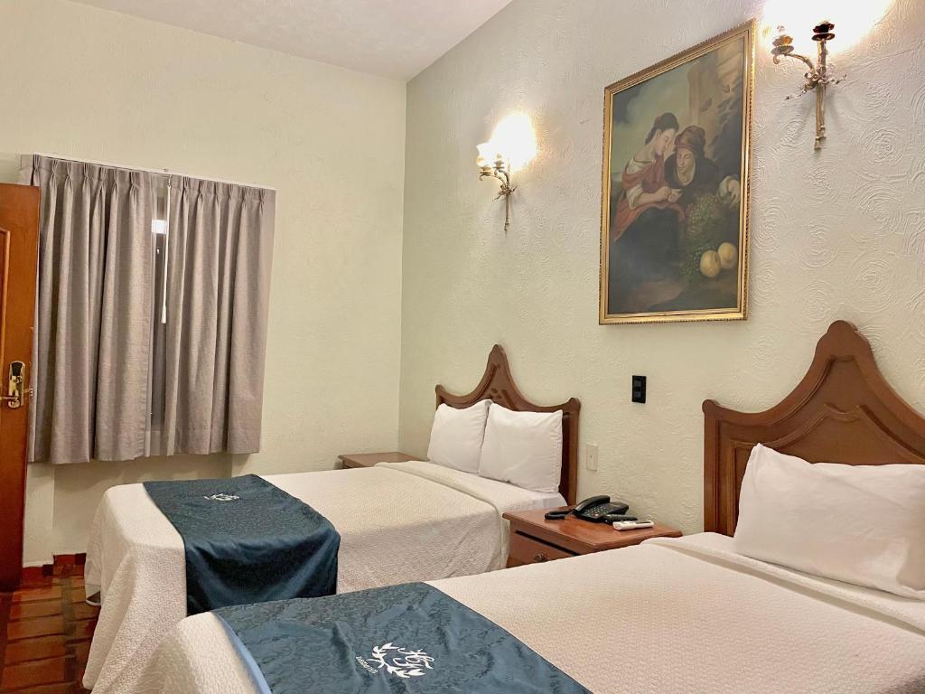 Postel nebo postele na pokoji v ubytování Hotel Frances