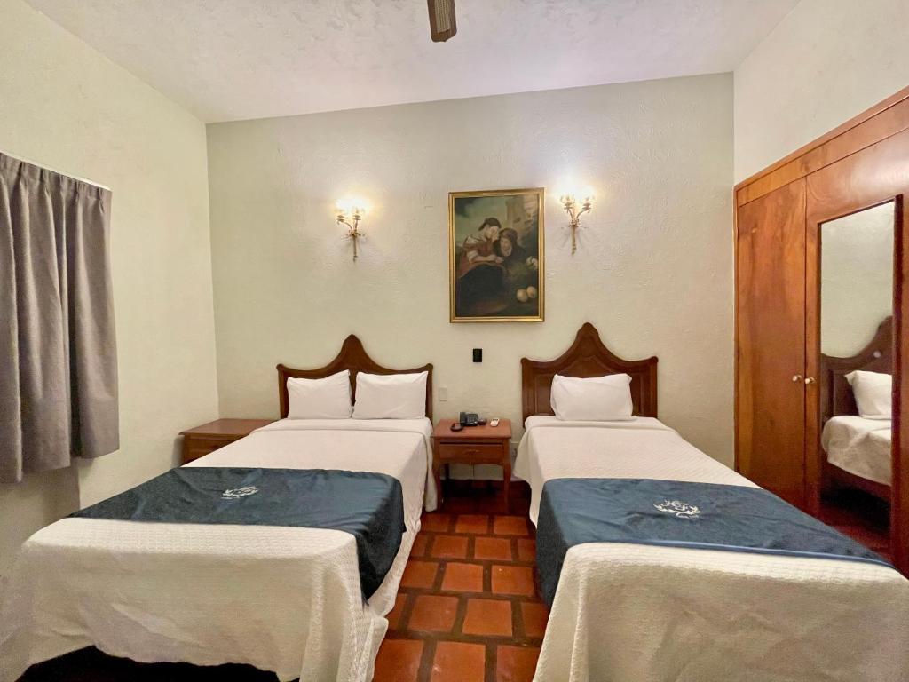 Postel nebo postele na pokoji v ubytování Hotel Frances