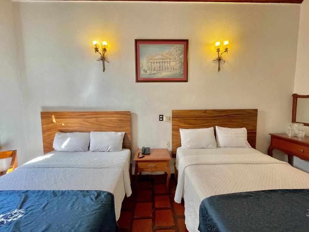 Postel nebo postele na pokoji v ubytování Hotel Frances
