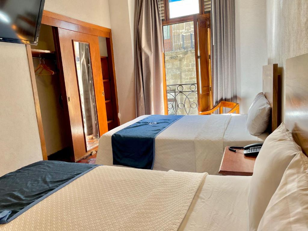 Postel nebo postele na pokoji v ubytování Hotel Frances
