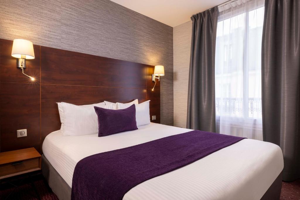 Un ou plusieurs lits dans un hébergement de l'établissement Hôtel L'Interlude