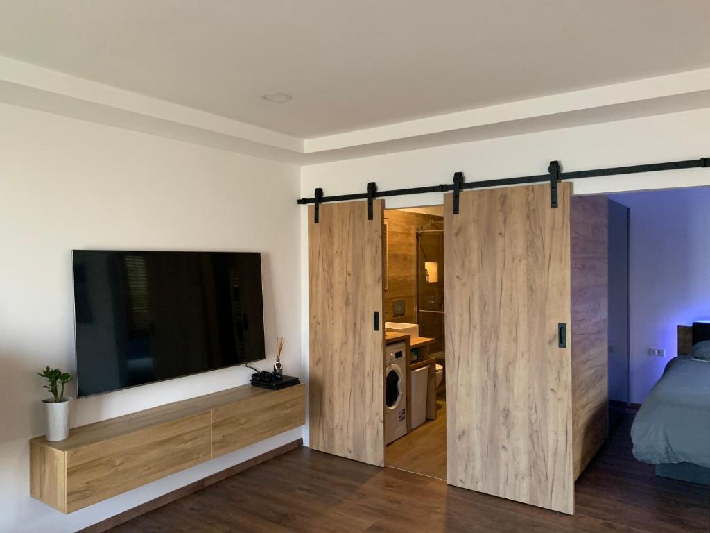 a bedroom with wooden sliding doors and a bed at Apartment Bella Vista 1 in Izola