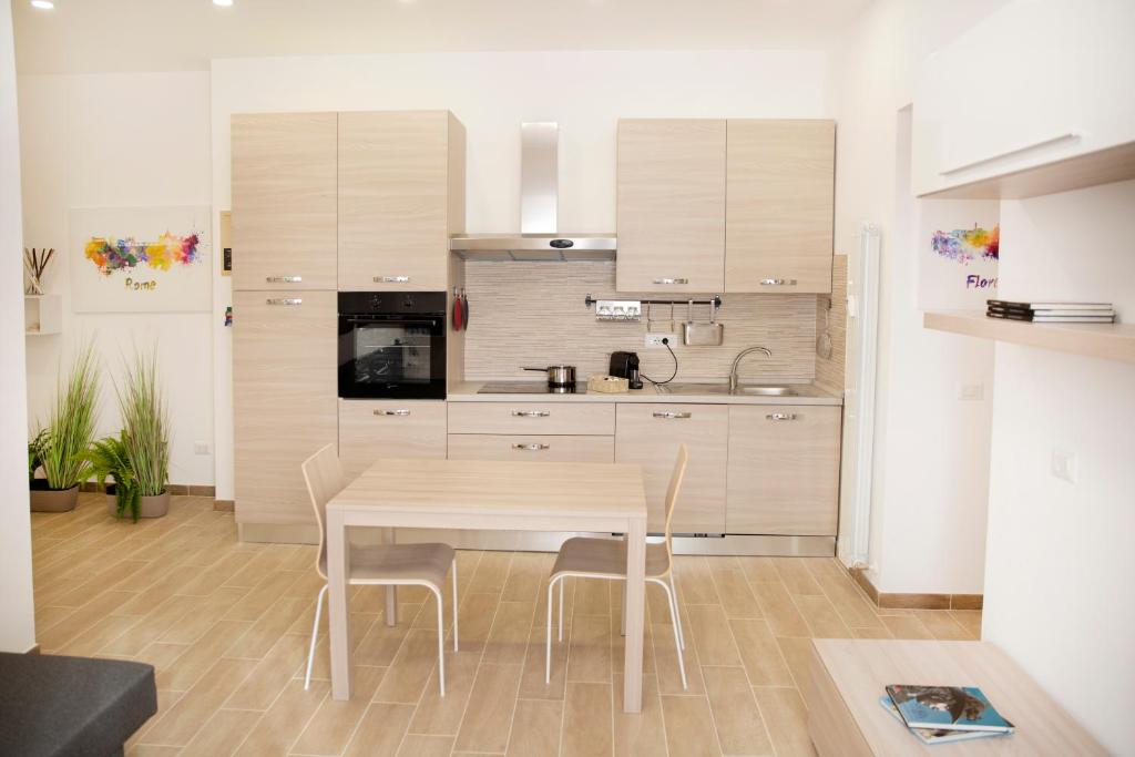 a kitchen with a table and chairs in a room at JN holiday home in Rome