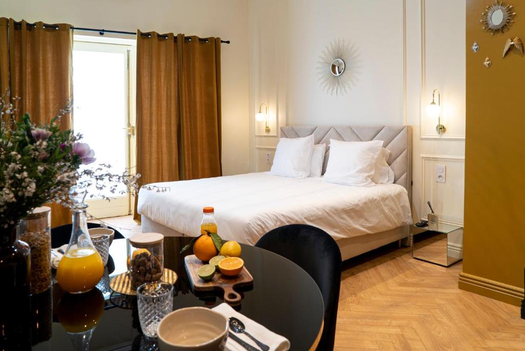 a hotel room with a bed and a table at Suite Ocre in Lyon