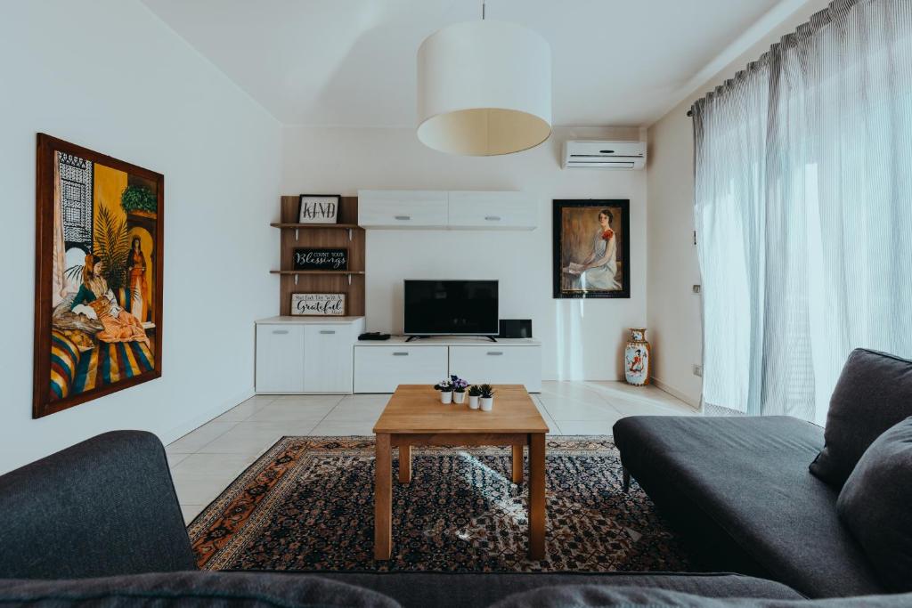 a living room with a couch and a coffee table at The Attico in Padenghe sul Garda