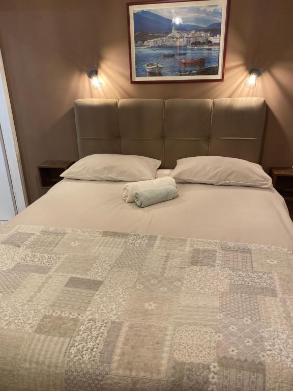 a bedroom with a bed with a quilt on it at Apartments Oliva in Poreč