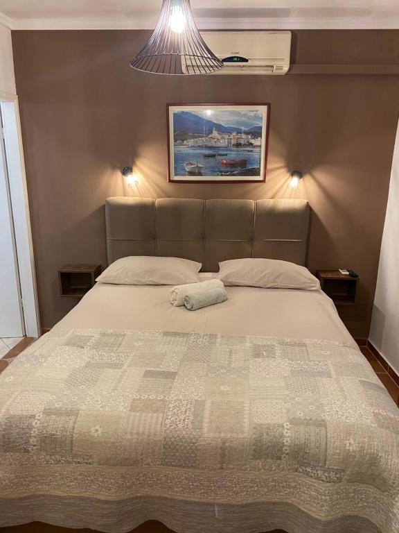 a bed in a bedroom with a picture on the wall at Apartments Oliva in Poreč
