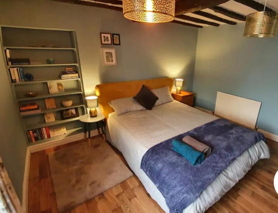 1 dormitorio con 1 cama grande con manta morada en Beautiful Cosy Townhouse 3 Double beds 2 Bathroom FREE PARKING en Kendal