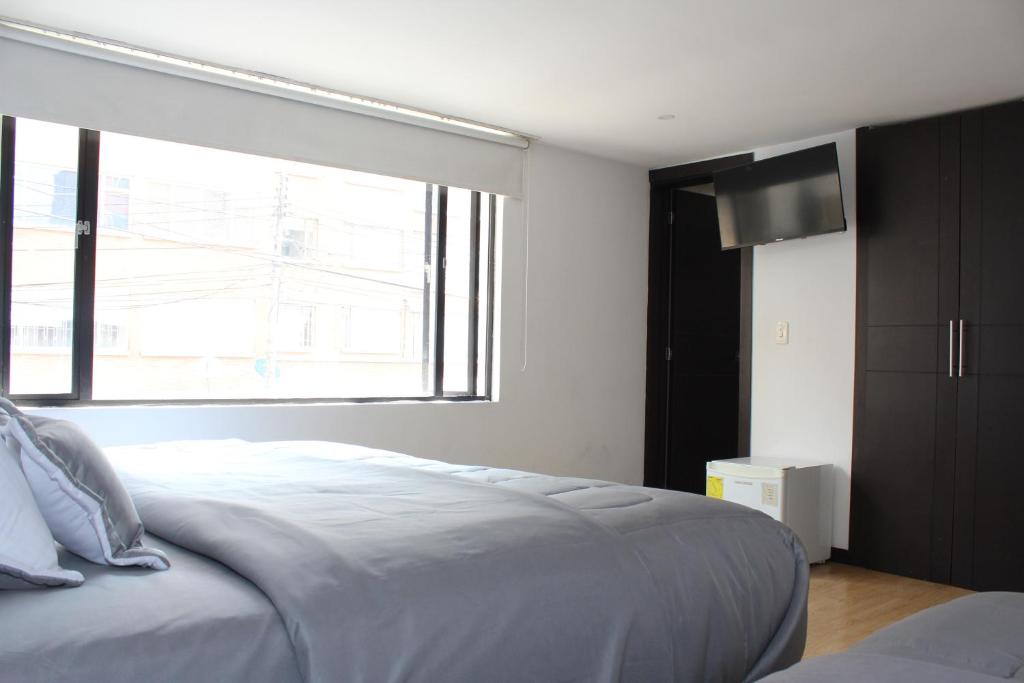 Postel nebo postele na pokoji v ubytování Hotel Montecarlo Boutique