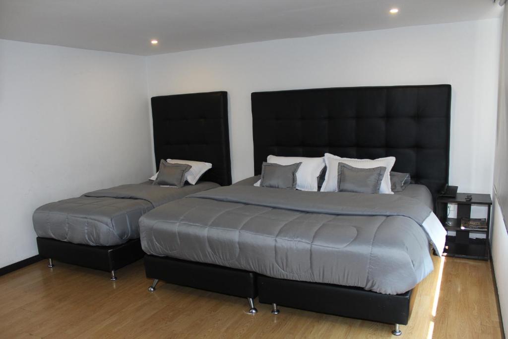 Postel nebo postele na pokoji v ubytování Hotel Montecarlo Boutique