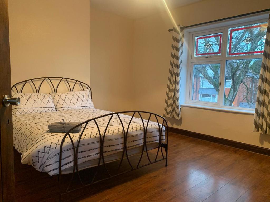 a bedroom with a bed and a window at 3/4 Bedroom House in Manchester