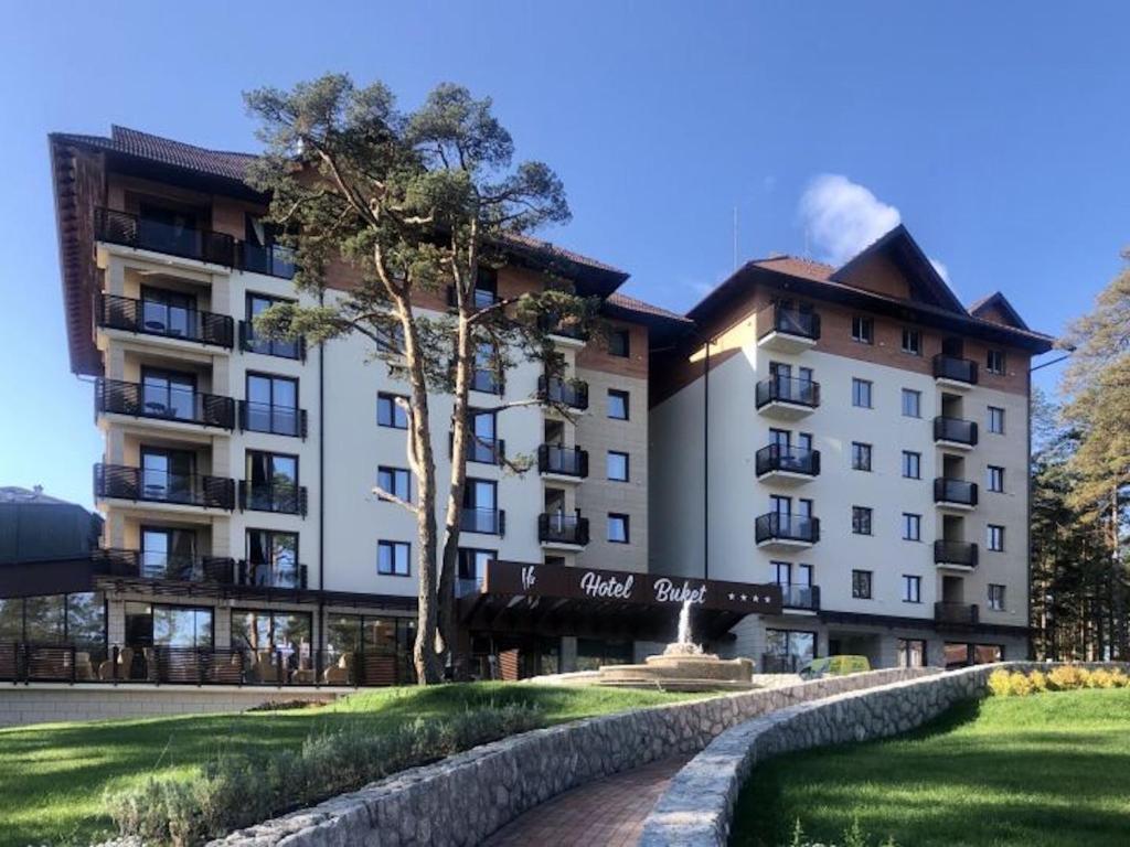 a large apartment building in front of a building at Time Out Lux apartmani in Zlatibor