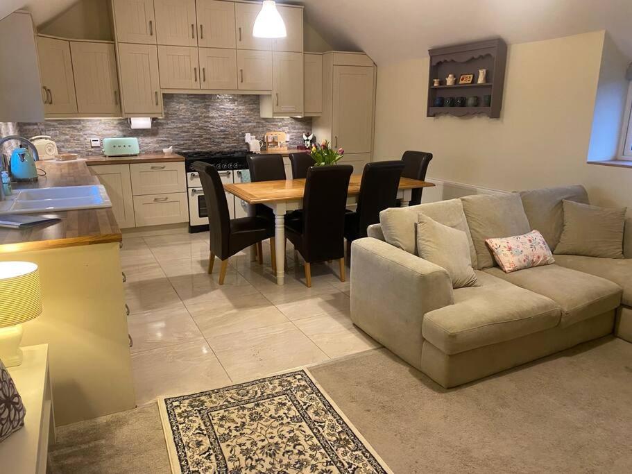 a living room with a couch and a table at Tullybrannigan Barn in Newcastle