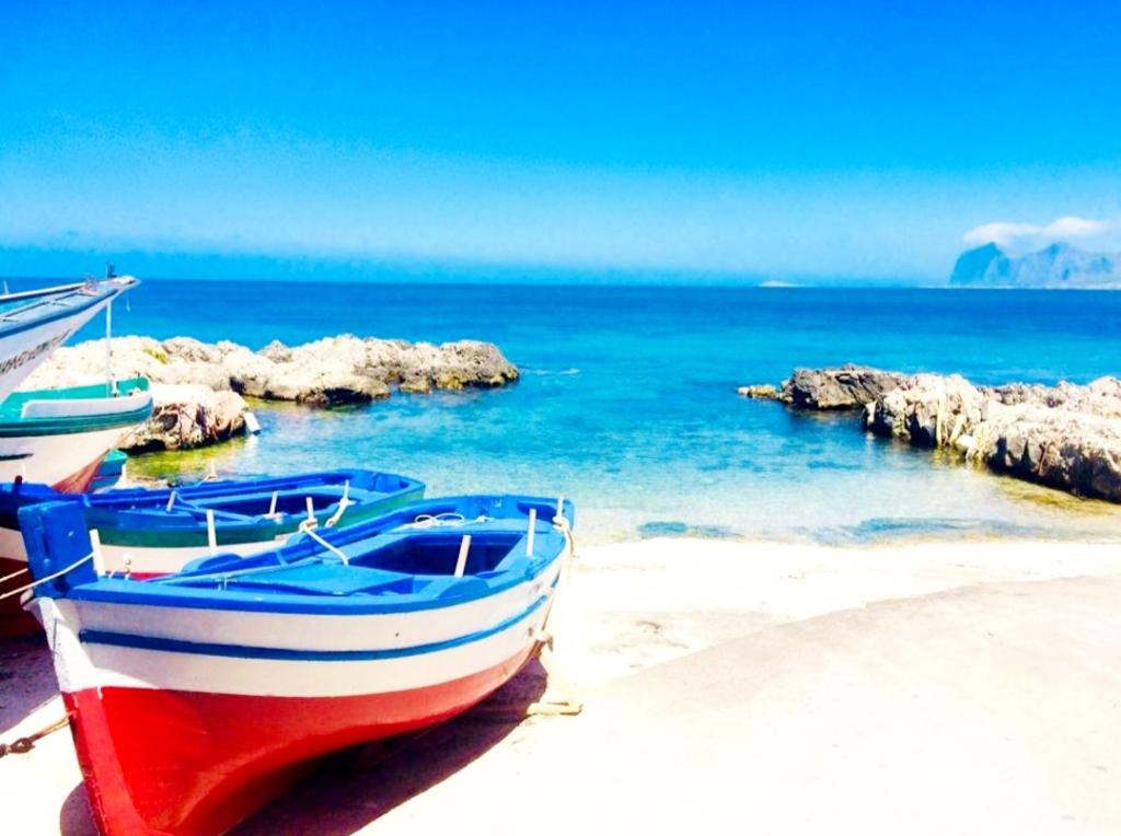 two boats sitting on the sand on a beach at Villa MiraMar Luxury Suite Palermo Airport in Carini