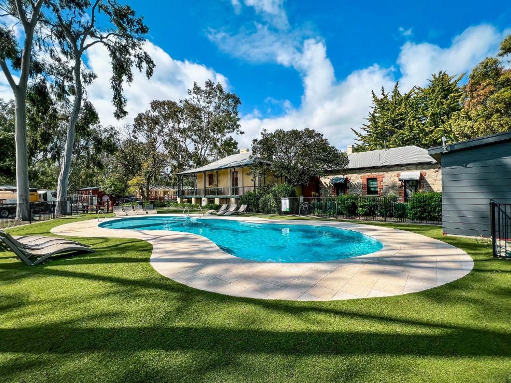 a swimming pool in the yard of a house at Levi Adelaide Holiday Park in Adelaide