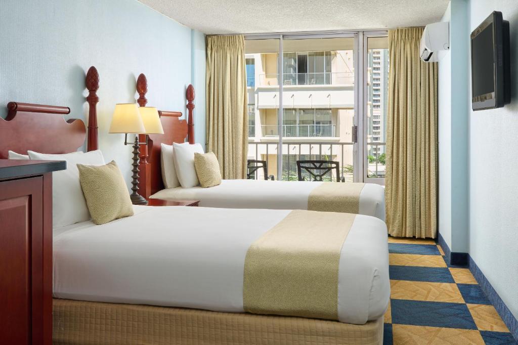 Postel nebo postele na pokoji v ubytování Ewa Hotel Waikiki