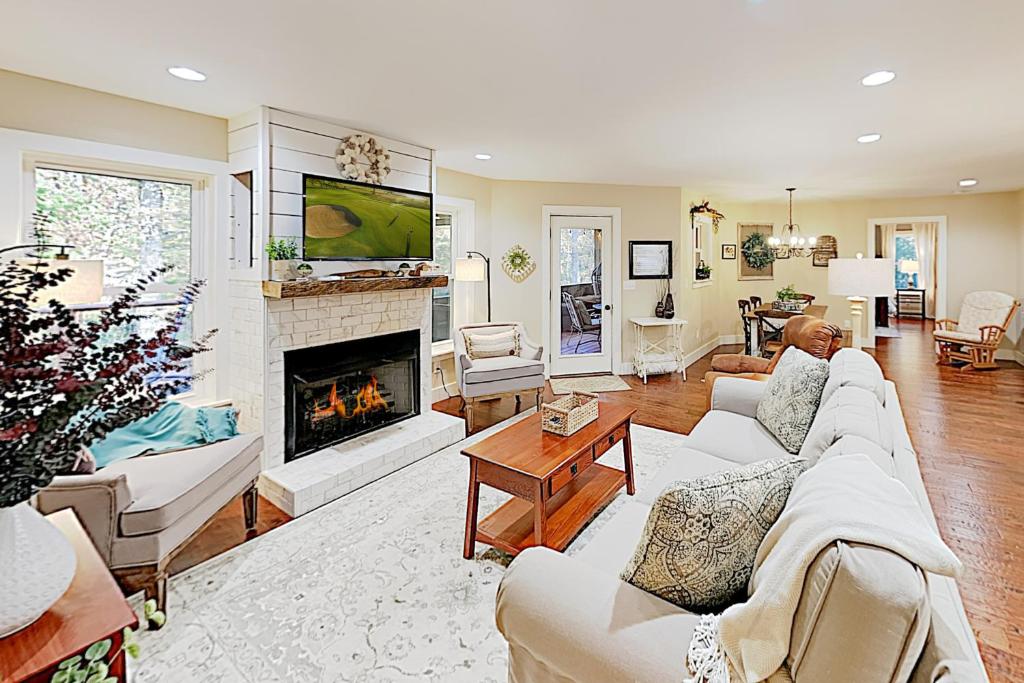 a living room with a couch and a fireplace at Dalton Abby Retreat in Black Mountain