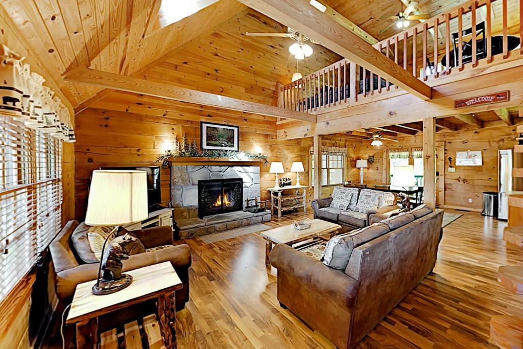 a living room with a couch and a fireplace at Mountain Lion's Tales in Gatlinburg