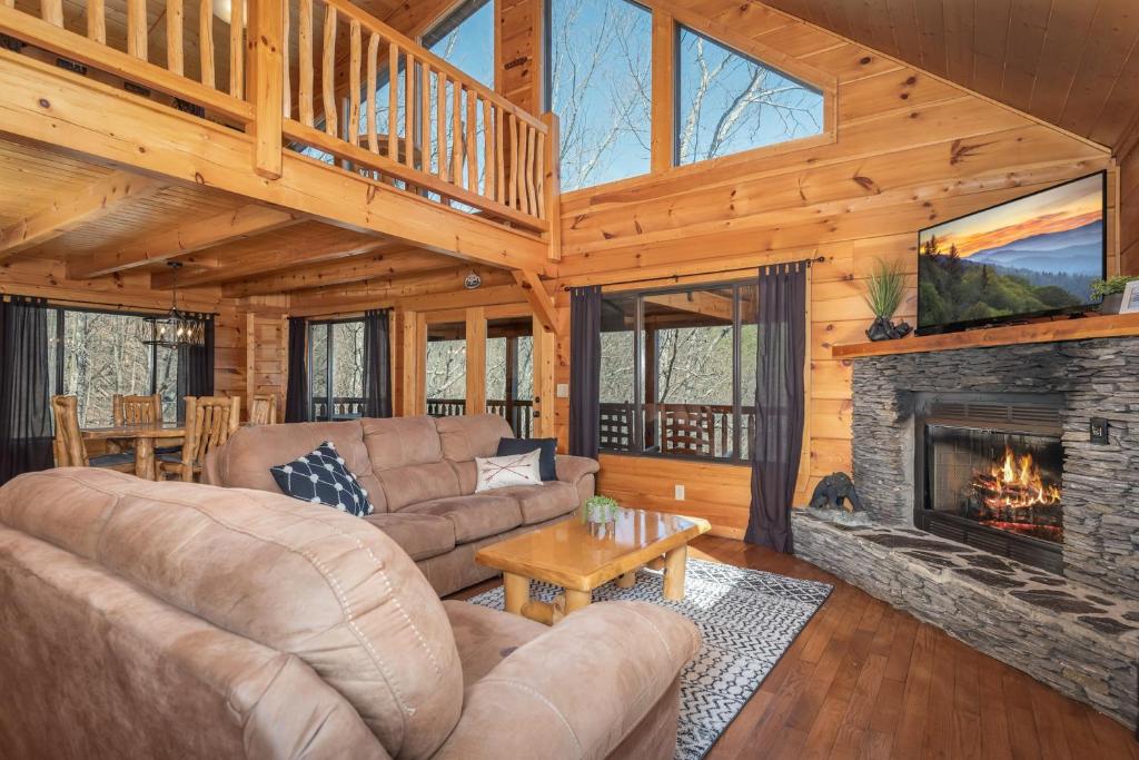 a living room with a couch and a fireplace at Dawns View in Sevierville