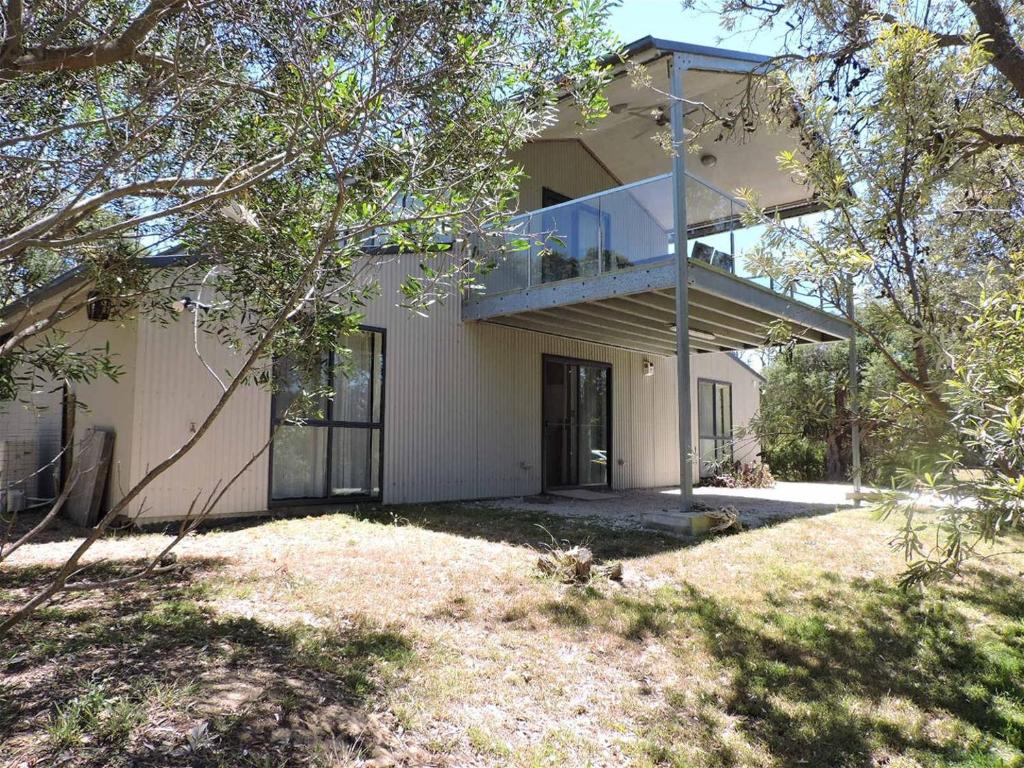 a house with a balcony on top of it at Paradise on The Boulevard - Beach Holiday Home 