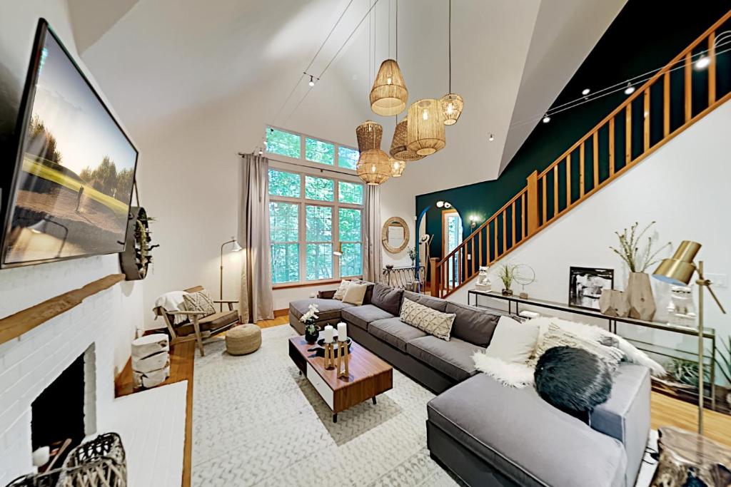 a living room with a couch and a fireplace at Heartwood Manor in Asheville