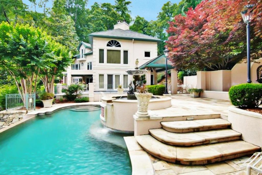 a swimming pool in a yard with a house at Villa Rosa in Lake Lure