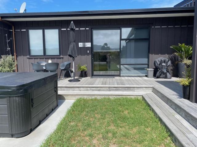 a house with a patio with a table and chairs at Northcoast Getaway in Mangawhai