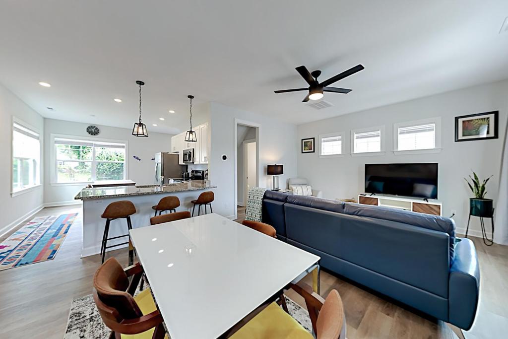 a living room with a blue couch and a table at Downtown Jewel in Wilmington