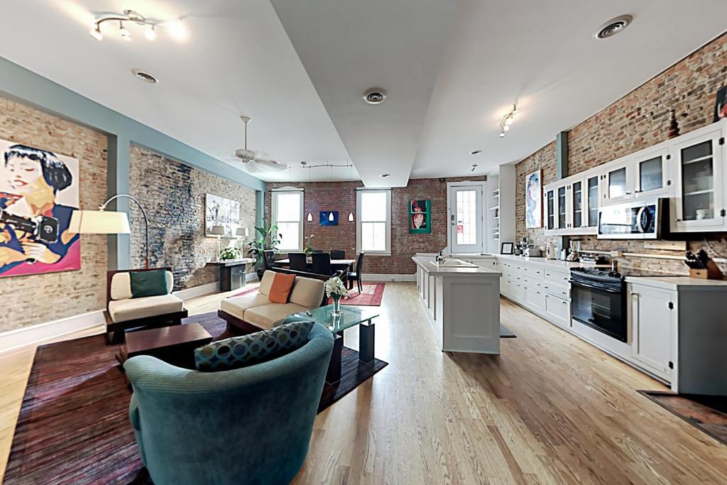 a large living room with a couch and a kitchen at Market Street Loft in Wilmington