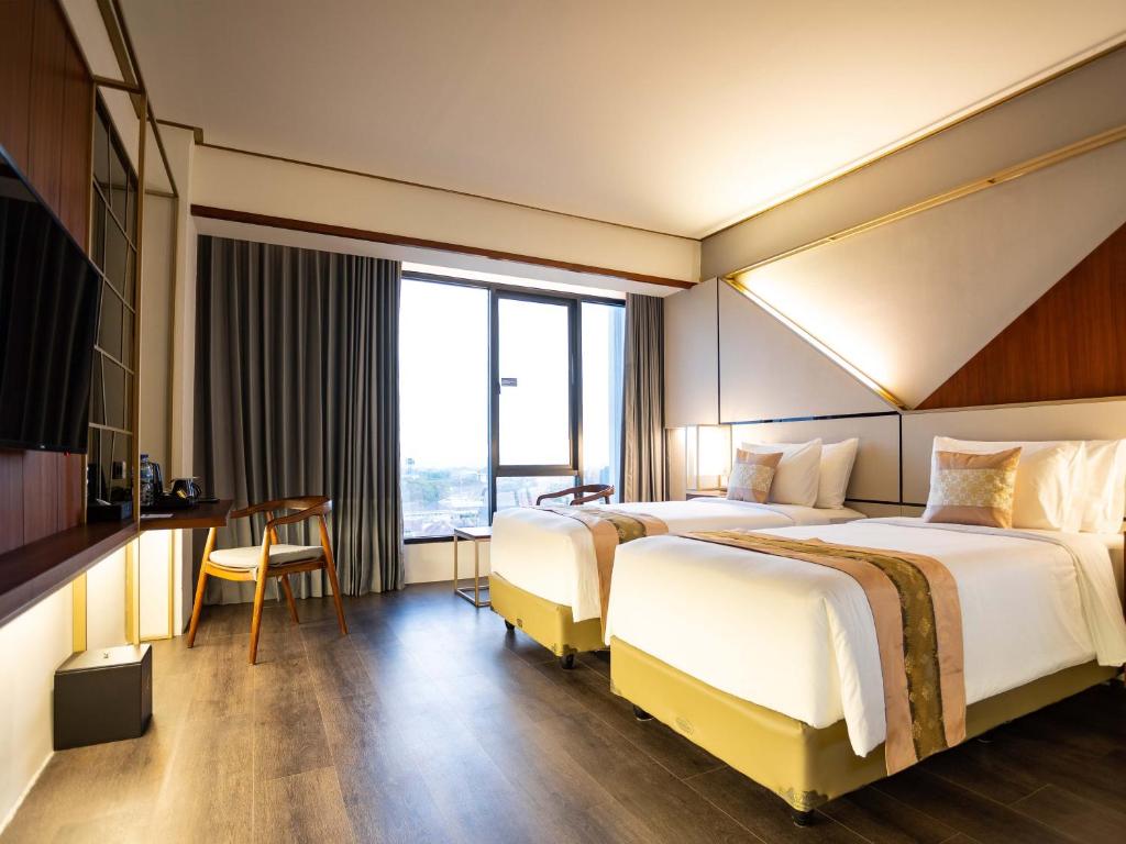 Ένα ή περισσότερα κρεβάτια σε δωμάτιο στο Rayz UMM Hotel Malang