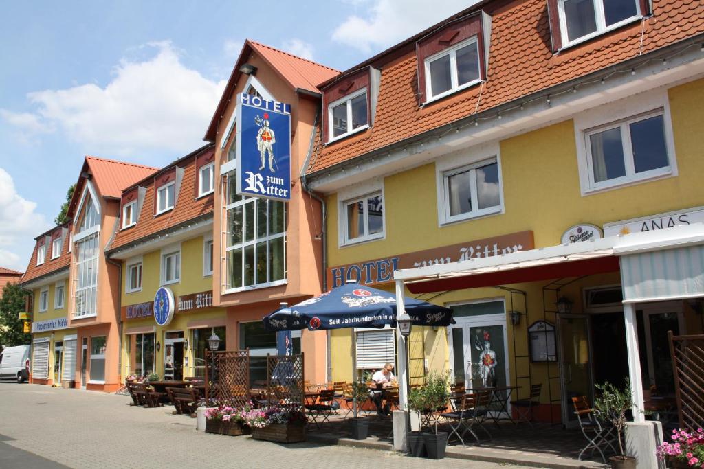 eine Reihe von Gebäuden auf einer Straße mit Tischen in der Unterkunft Hotel zum Ritter Nidderau in Nidderau