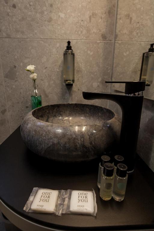 a sink in a bathroom with candles on a table at Boutique Hotel Bura 45N in Senj