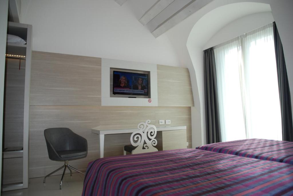 Televízia a/alebo spoločenská miestnosť v ubytovaní Hotel Lugano Torretta
