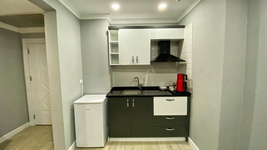 A kitchen or kitchenette at Heaven Suite Hotel