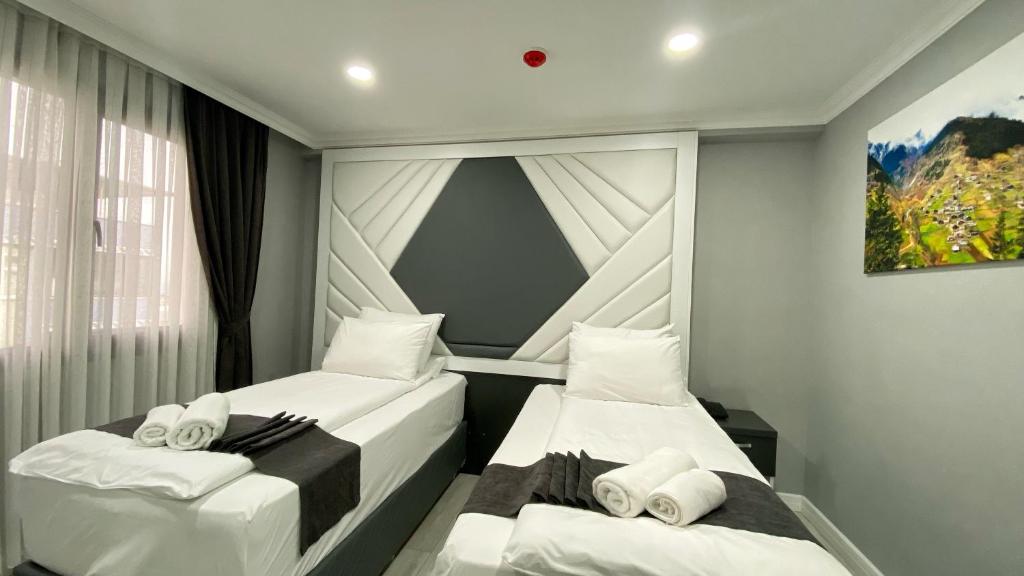 a bedroom with two beds and a window at Heaven Suite Hotel in Trabzon