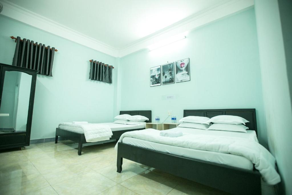 Postel nebo postele na pokoji v ubytování Nhà Nghỉ Kim Lài - Đối diện bệnh viện tỉnh Gia Lai -132 Tôn Thất Tùng