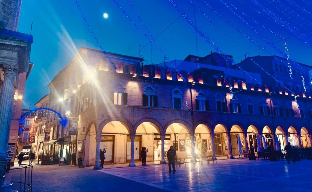 a city street with a large building at night at Lovely 2 bedroom apartment steps from Ascoli's stunning Piazza del Popolo in Ascoli Piceno