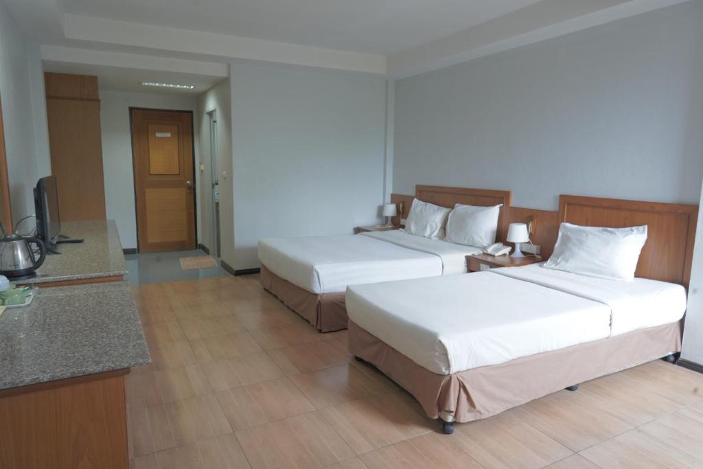 Postel nebo postele na pokoji v ubytování Sport Inn
