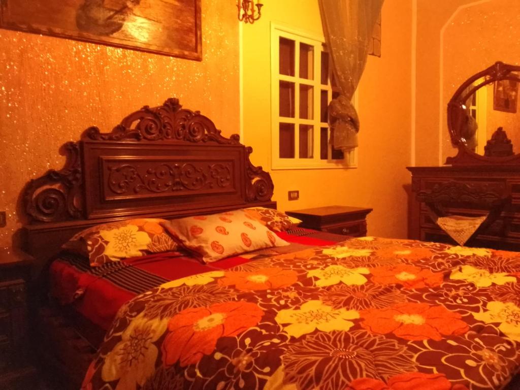 a bedroom with a large bed with an orange at Maison de rêve in Tabarka