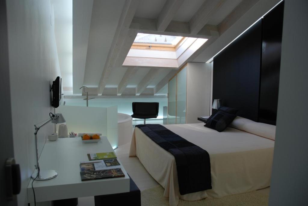 a bedroom with a bed and a skylight at Posada Real La Pascasia in Puebla de Sanabria