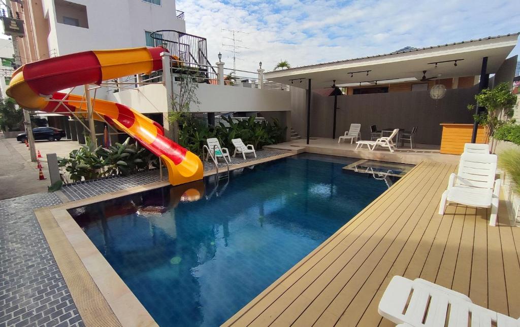 a pool with a slide in the middle of a house at Baan Manthana House in Hua Hin