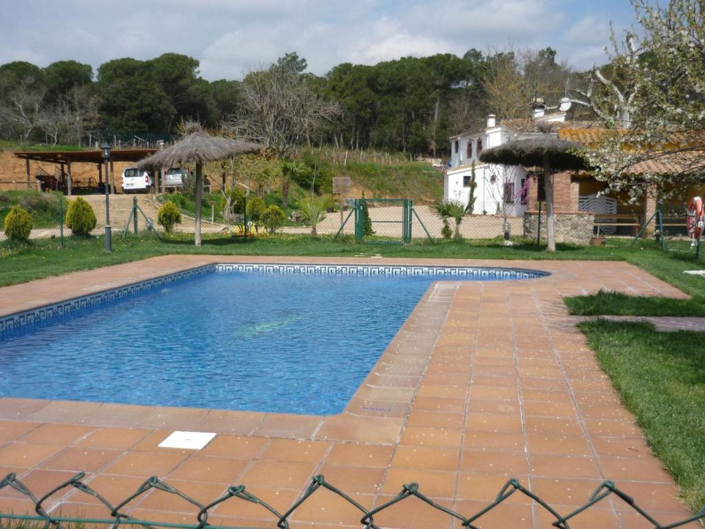 una piscina frente a una casa en Belvilla by OYO Can Rajoler, en Riudarenes