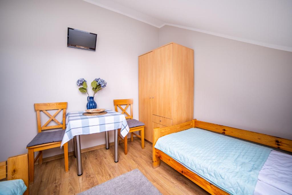Posteľ alebo postele v izbe v ubytovaní Gościniec pod Lilijką