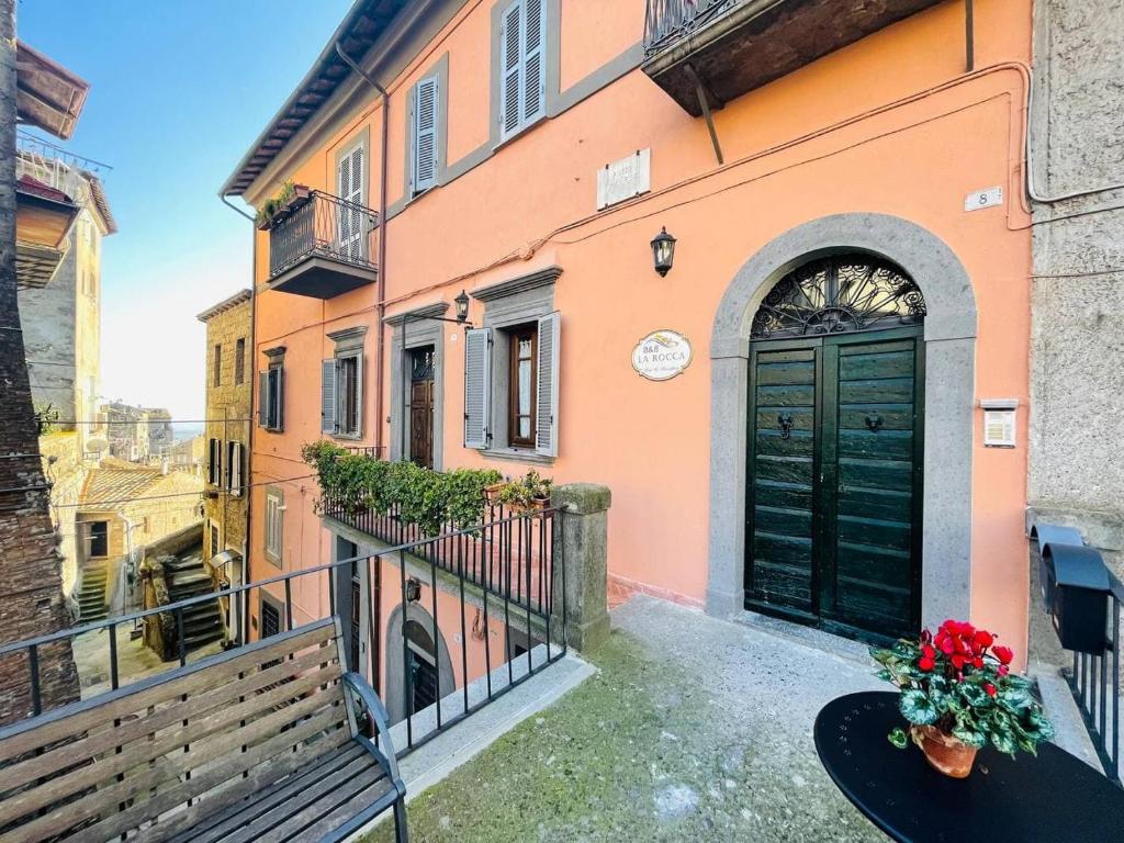 budynek z zielonymi drzwiami i balkonem w obiekcie B&B La Rocca w mieście Caprarola