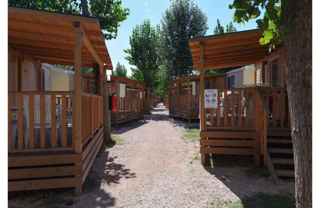 a row of wooden cabins in a row at Club del Sole Rimini Family Resort in Rimini