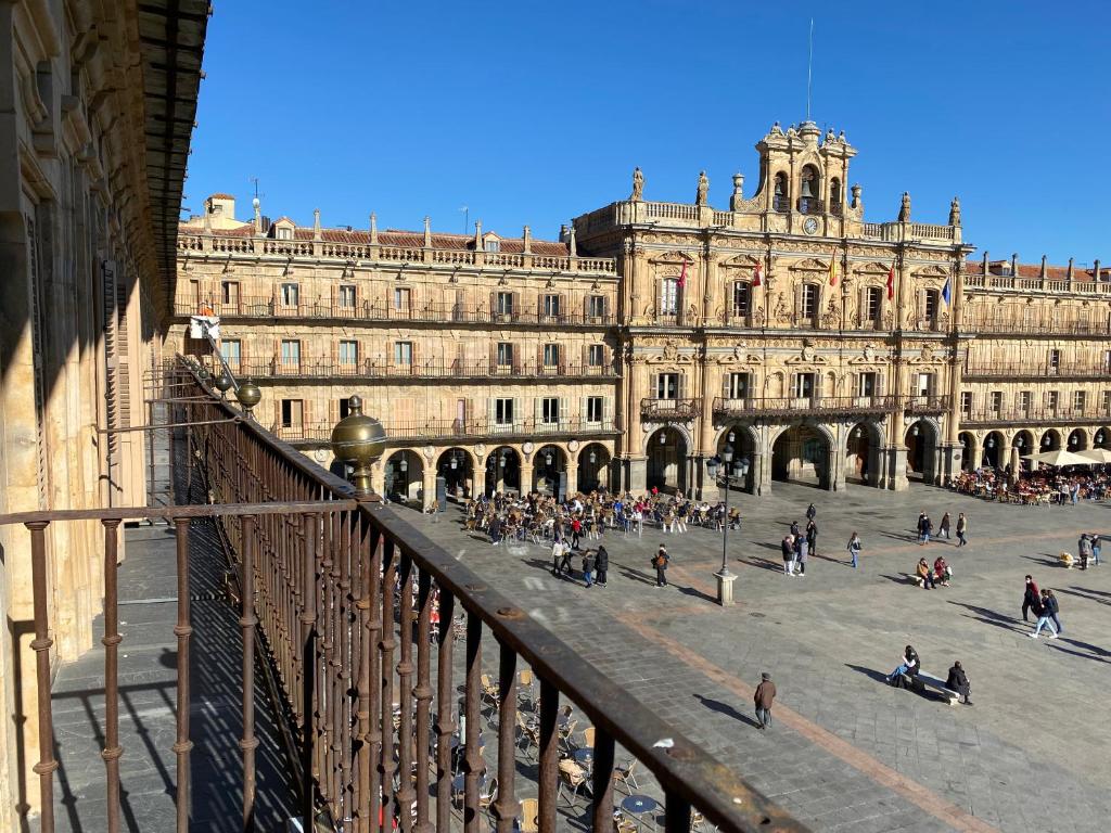 a large building with people walking in front of it at Plaza Mayor 19-Precioso estudio único en Salamanca in Salamanca