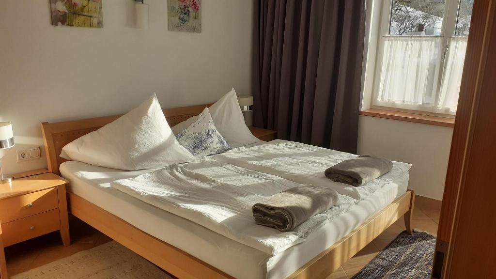 a bedroom with a bed with two pillows on it at LunzFerien in Lunz am See