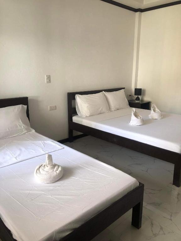 Postel nebo postele na pokoji v ubytování Hotel Oasis Port Barton